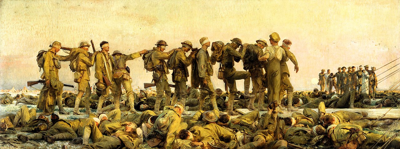 A painting showing injured First World War soldiers. The main focus is a line of 10 men being led by another solider. The ten men have bandages over their eyes and have one hand on the shoulder of the person in front of them. One the floor surrounding these standing men are many more with bandages on their eyes. They're all laying around as they recover.  