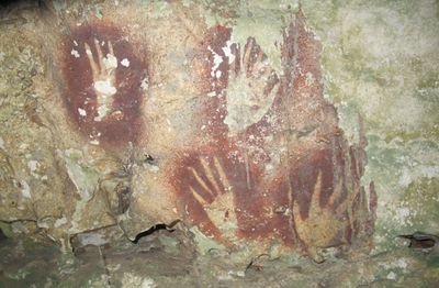 The world's oldest known rock art: Narrowed finger hand stencils that have been created by blowing ochre (red) pigment over them, from Leang Jarie, Maros, Sulawesi