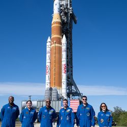 NASA astronaut Andre Douglas and CSA (Canadian Space Agency) astronaut Jenni Gibbons and prime crewmembers NASA astronauts Victor Glover, Reid Wiseman, CSA (Canadian Space Agency) astronaut Jeremy Hansen, and NASA astronaut Christina Koch, pose for a picture with NASA’s Space Launch System (SLS) rocket and Orion spacecraft,