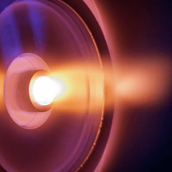 A cilinrical entrance shows the flow of hot plasma glowing orange
