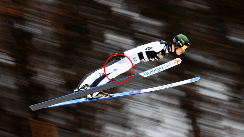 An athlete performs a ski jump.