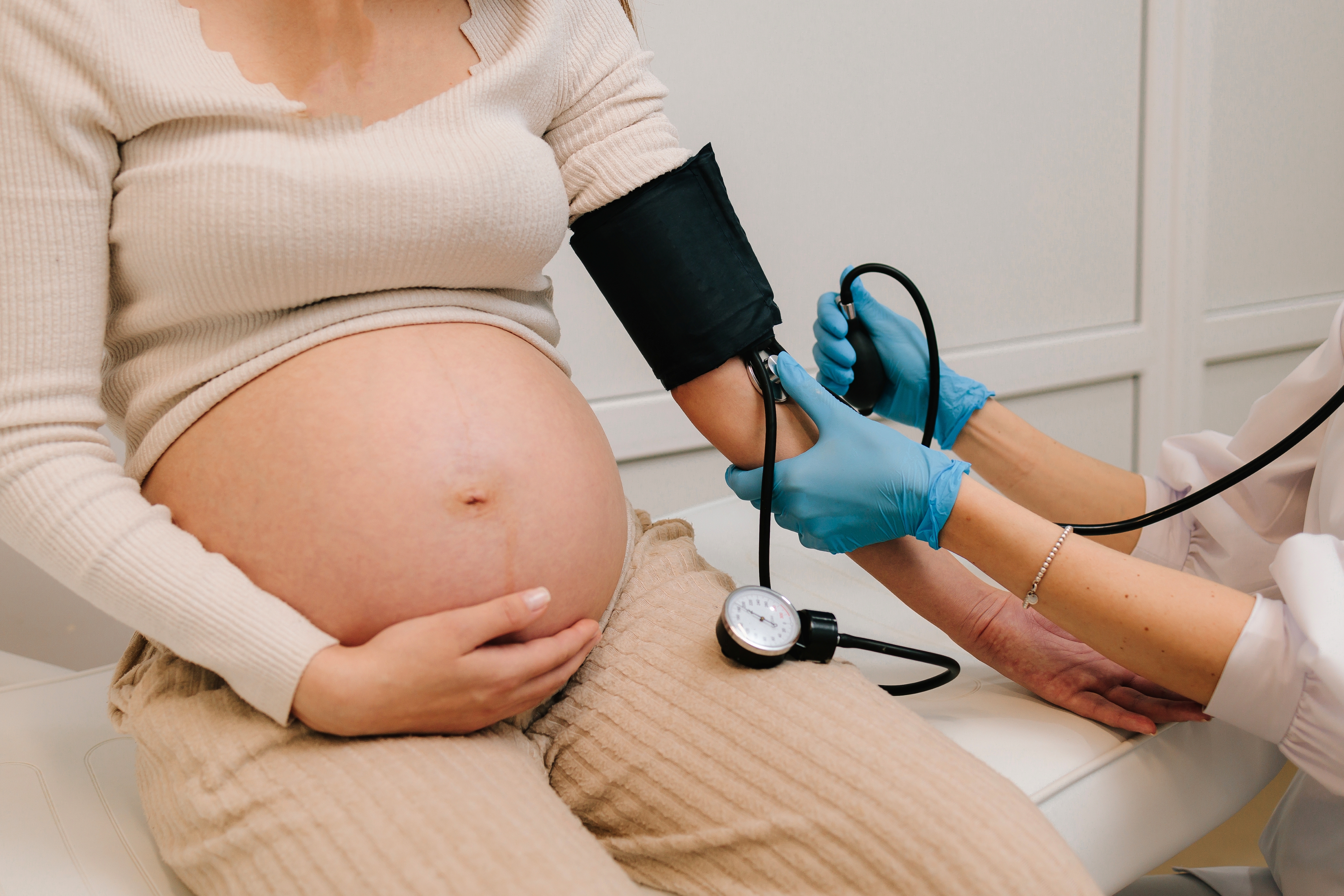 pregnant person having their blood pressure measured