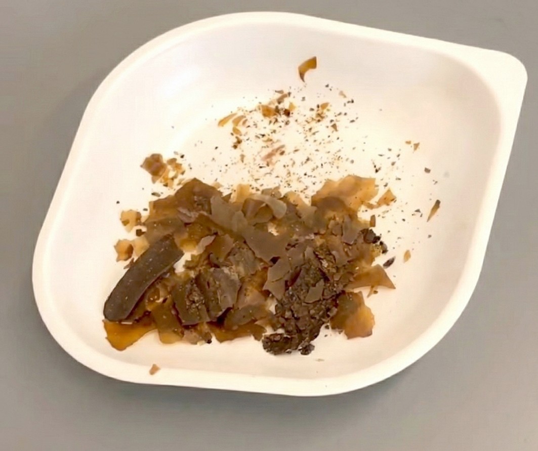 A photo of what looks like chunks of caramel in polystyrene bowl. The flakes are a brown color that ranges from light to dark, depending on their size. A photo of what looks like chunks of caramel in polystyrene bowl. The flakes are a brown color that ranges from light to dark, depending on their size.