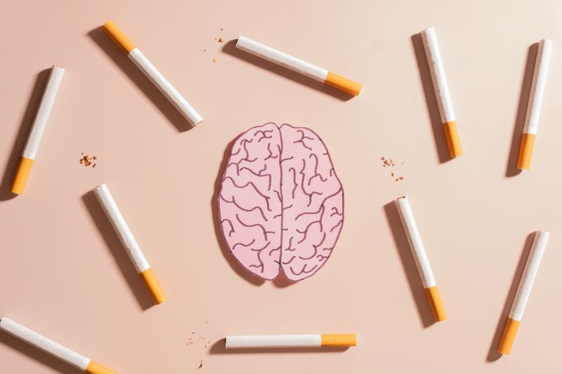 illustration of 2D human brain surrounded by cigarettes