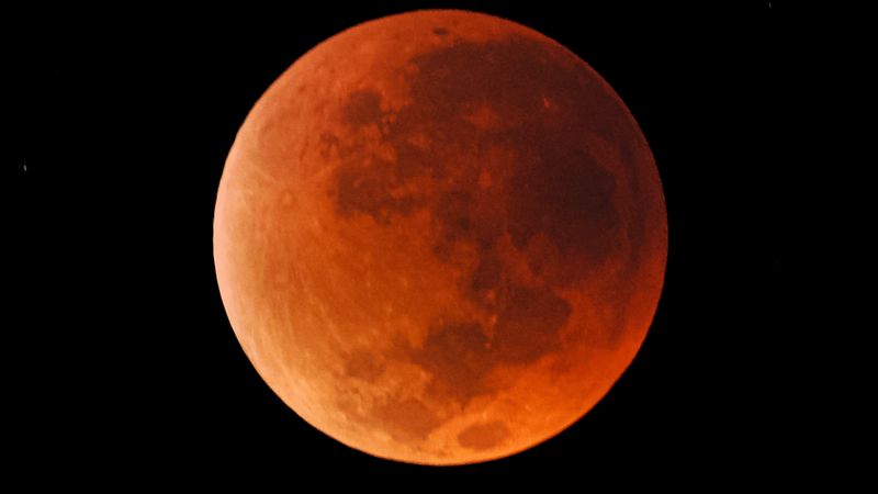 The moon looking rust orange during a total lunar eclipse