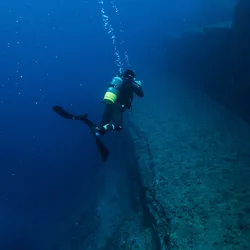 A diver at Yonaguni Monument. Rocks resembling steps underneath the sea.
