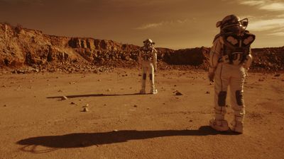 two astronauts looking at a martian landscape