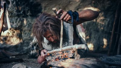 Prehistoric human making fire
