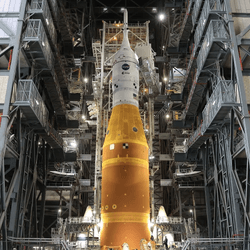The top of the rocket is visible among the scaffolding of the vehicle assembly building