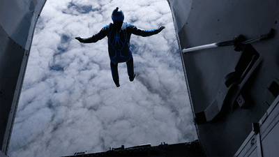 A skydiver jumping out of an airplane.
