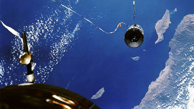 The Agena target vehicle over Earth, tethered to Gemini XI in the foreground.