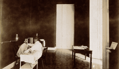 A photograph from 1902 shows a tuberculosis patient undergoing an examination in Cuba.