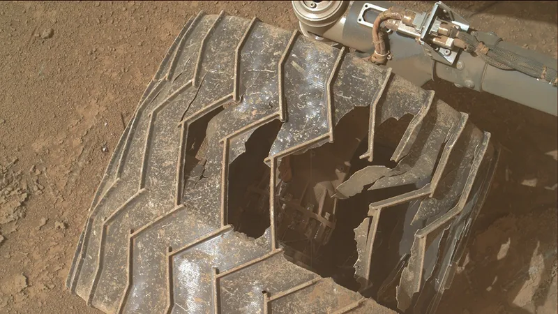 Curiosity's wheel, looking severely damaged.