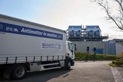 A truck at cern with a sing on its side that says antimatter in motion.