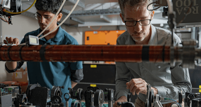 Yogesh Sridhar and Dr Sean Hodgman (right) making adjustments on the way to demonstrating the entanglement of atoms' momentum for the first time