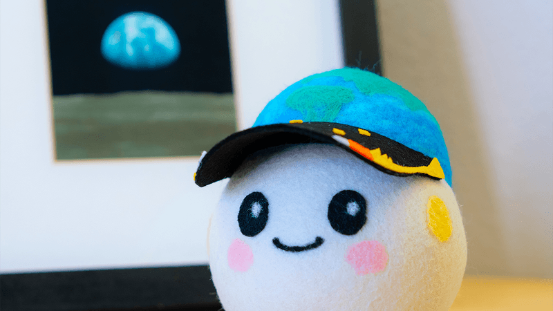 Artemis II's zero gravity indicator: A small ball plushie, with an Earth and stars hat.