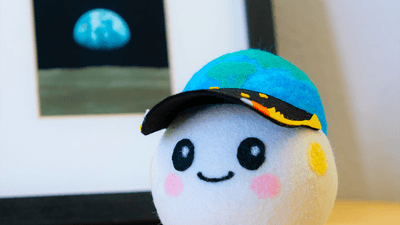 Artemis II's zero gravity indicator: A small ball plushie, with an Earth and stars hat.