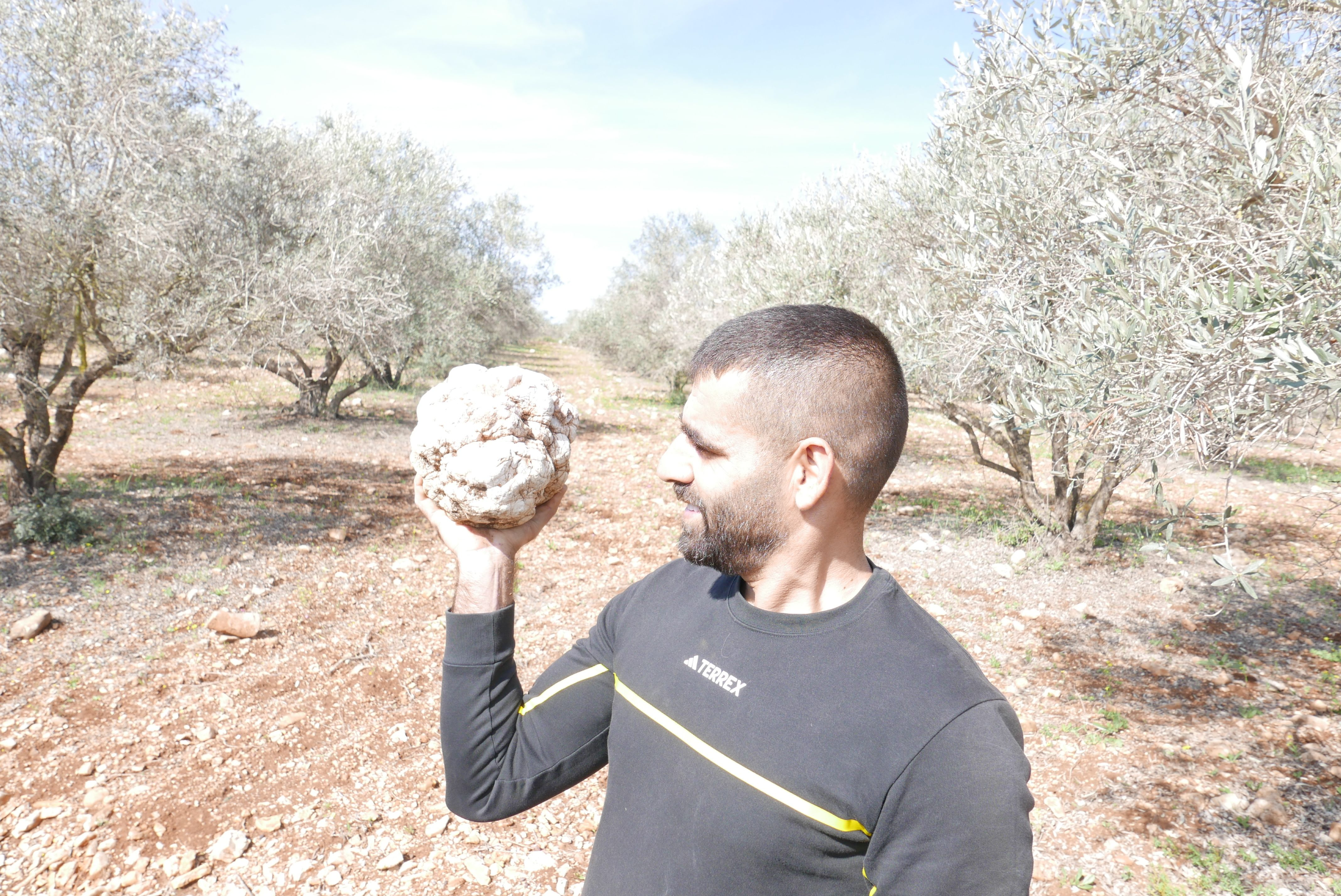 Muataz Shalata holds a spheroid made from a geode.