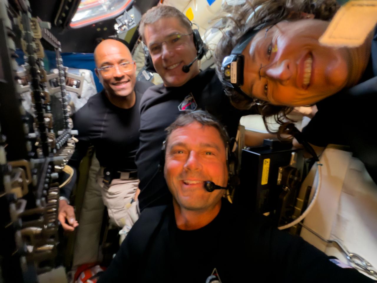 The four crew members of the Artemis mission smile for a selfie aboard the Orion spacecraft.
