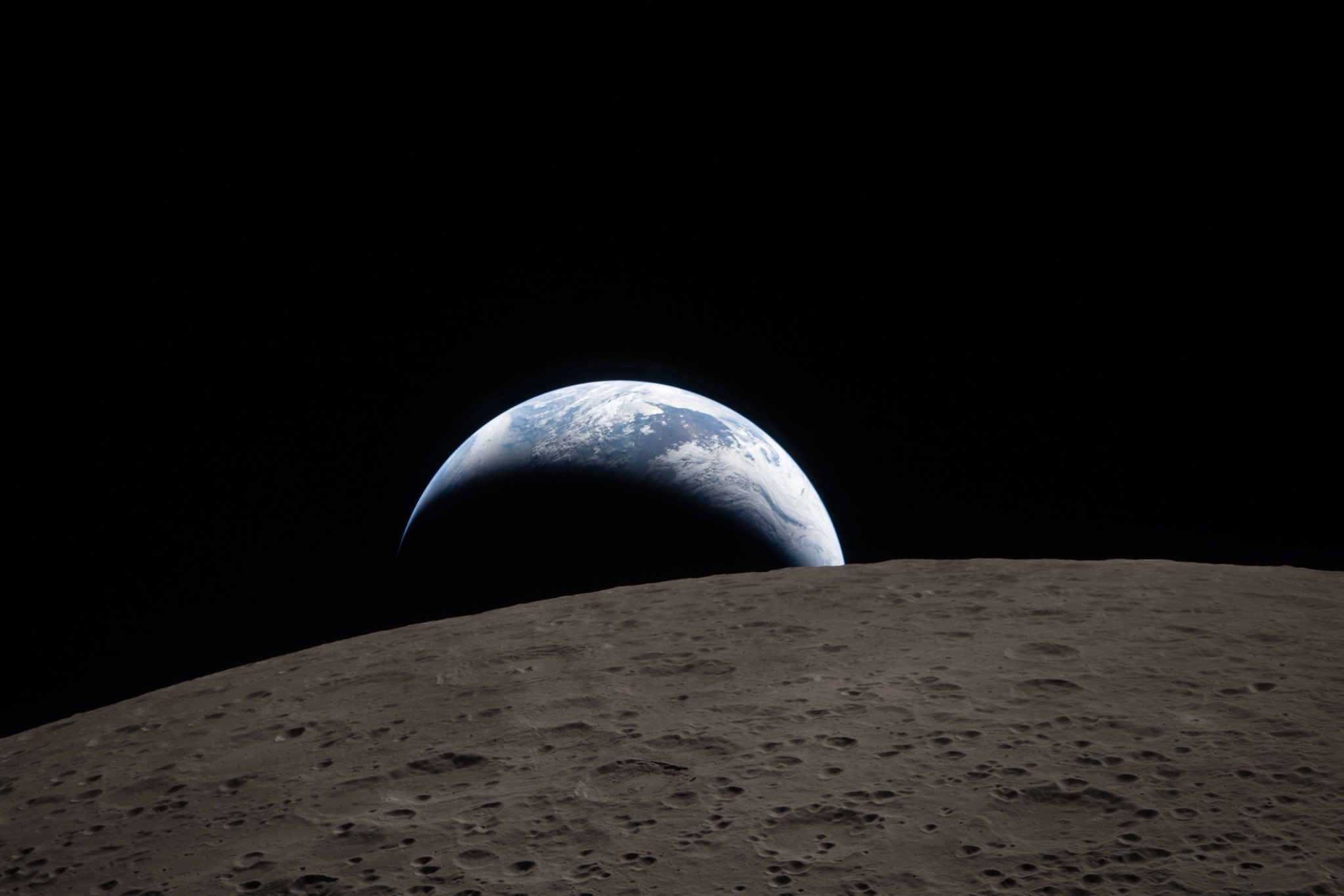 Earth setting behind the moon as seen from Artemis II.