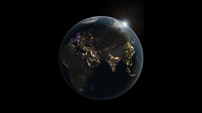 The image shows a globe at night focusing on europe, africa, and asia. Western europe lights are mostly purple, most of asia is golden, and the middle east is white.