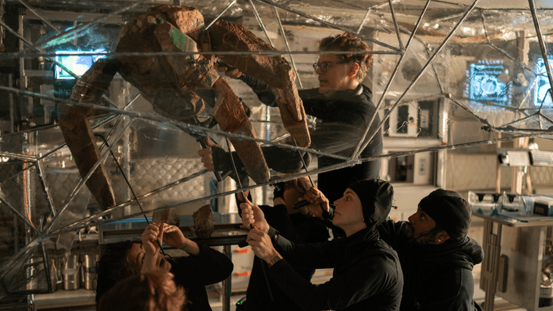 puppet designer james ortiz operates rocky the eridian puppet with aid of "the rocketeets"