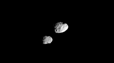 Janus (right) and Epimetheus look like they're almost touching in this photo, in keeping with their almost identical orbits, but this image was taken when they were thousands of kilometers apart.