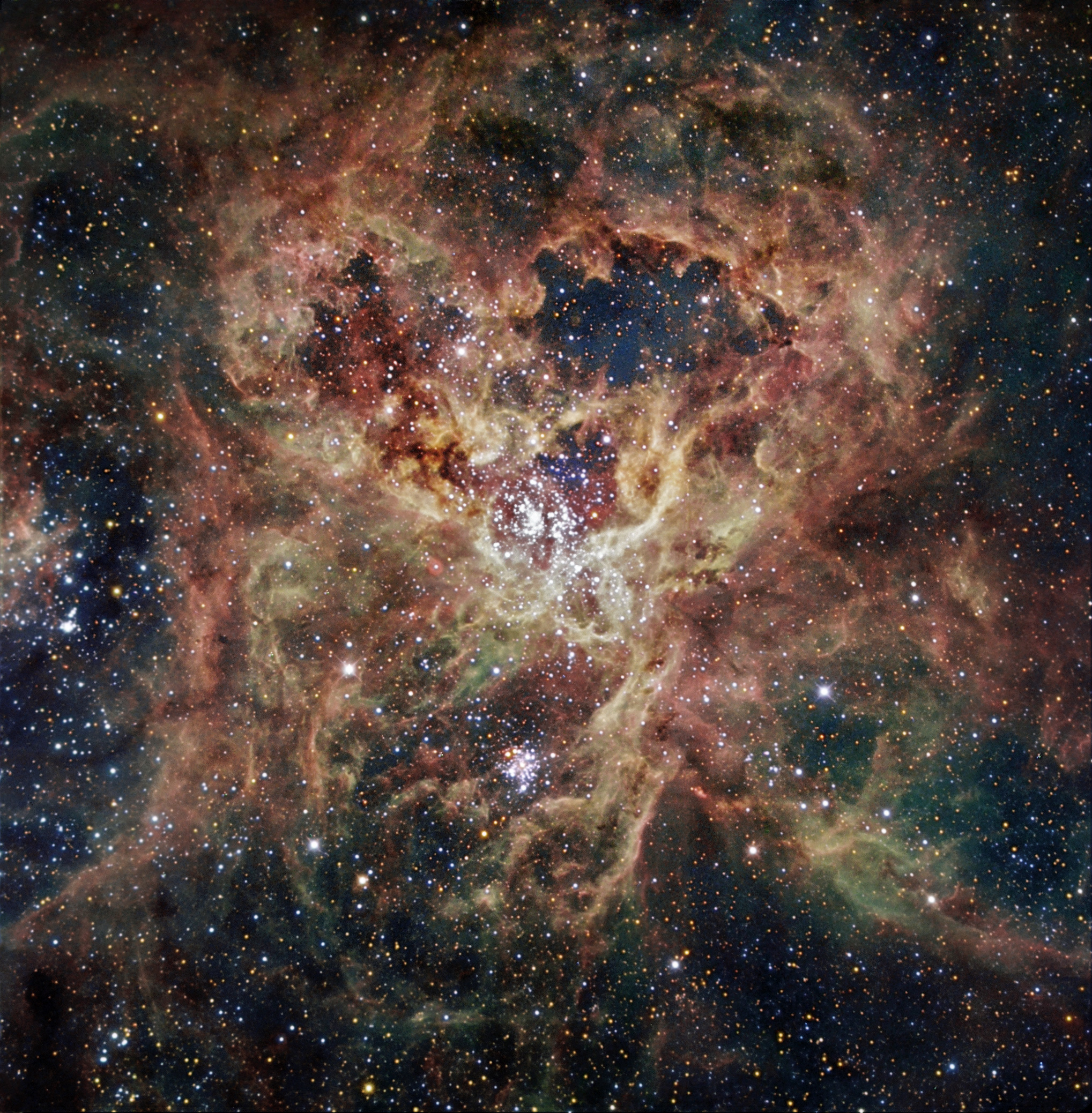 An image showing a birghty very wispy nebula with sever star clusters including a massive one in the middle An image showing a birghty very wispy nebula with sever star clusters including a massive one in the middle