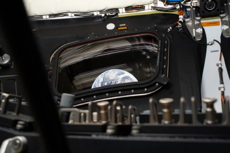 a bit of Earth is visible through the quadrangular window a bit of Earth is visible through the quadrangular window