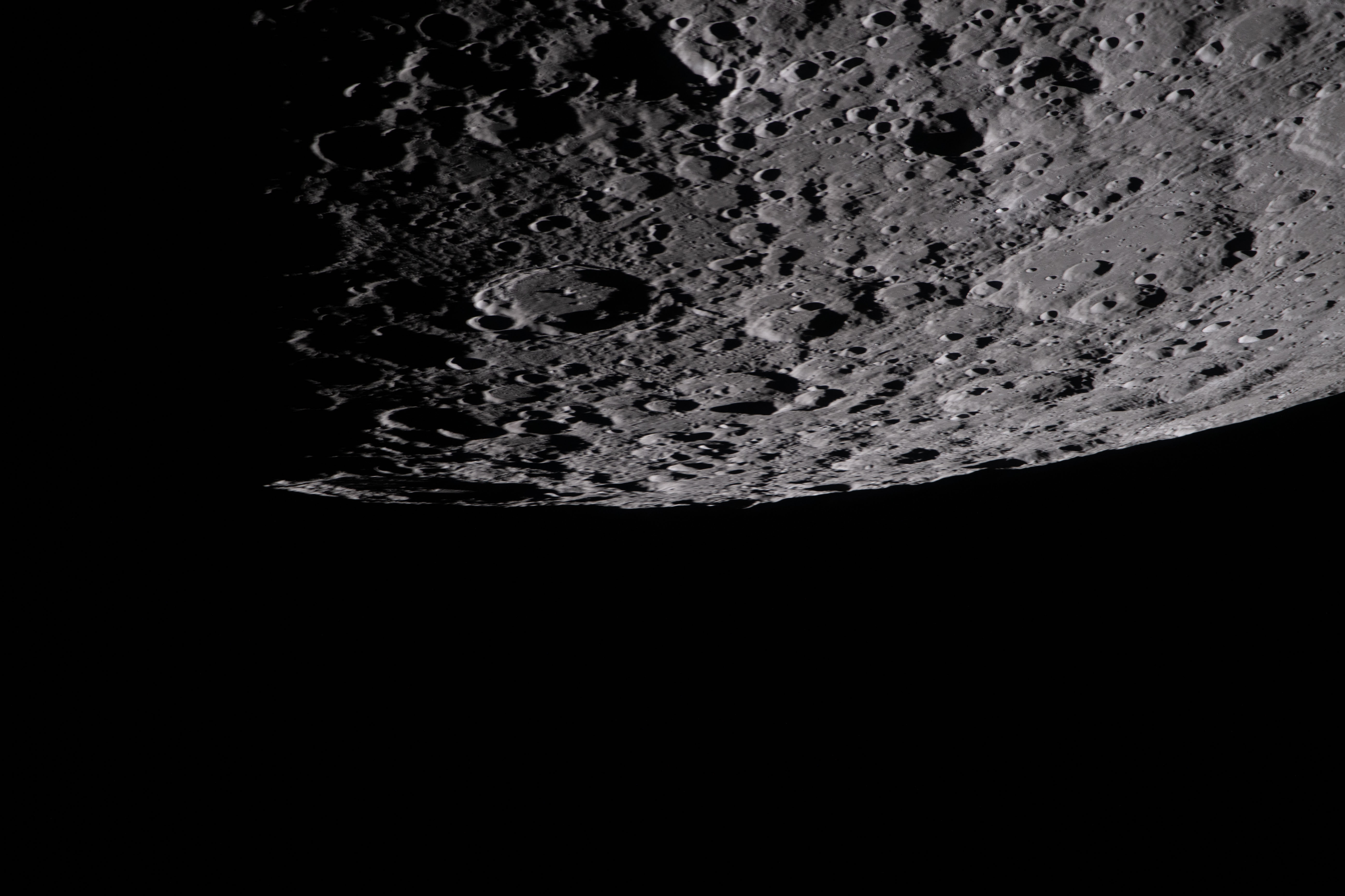 the cratered surface of the Moon is seen in this image, where the moon occupies the top halg the cratered surface of the Moon is seen in this image, where the moon occupies the top halg