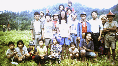 The Tasaday people, posing for a photograph in modern clothing.