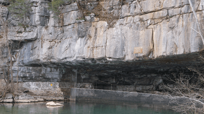the cave entrance is half submerged in water