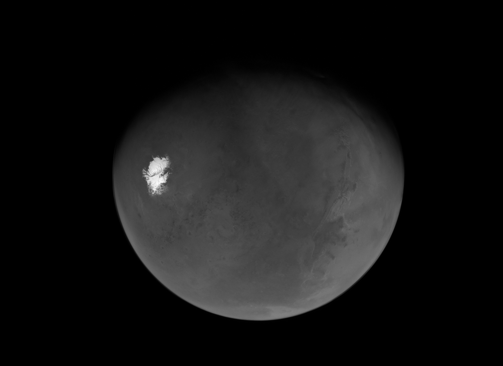 black and white view of Mars. The south pole is an icy splotch on the left