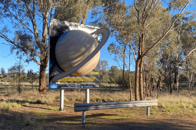 A fibreglass model of Saturn on the Siding Spring Solar System Drive, made at thirty-eight million times smaller than the real thing, like the other planets on the drive and the distances between