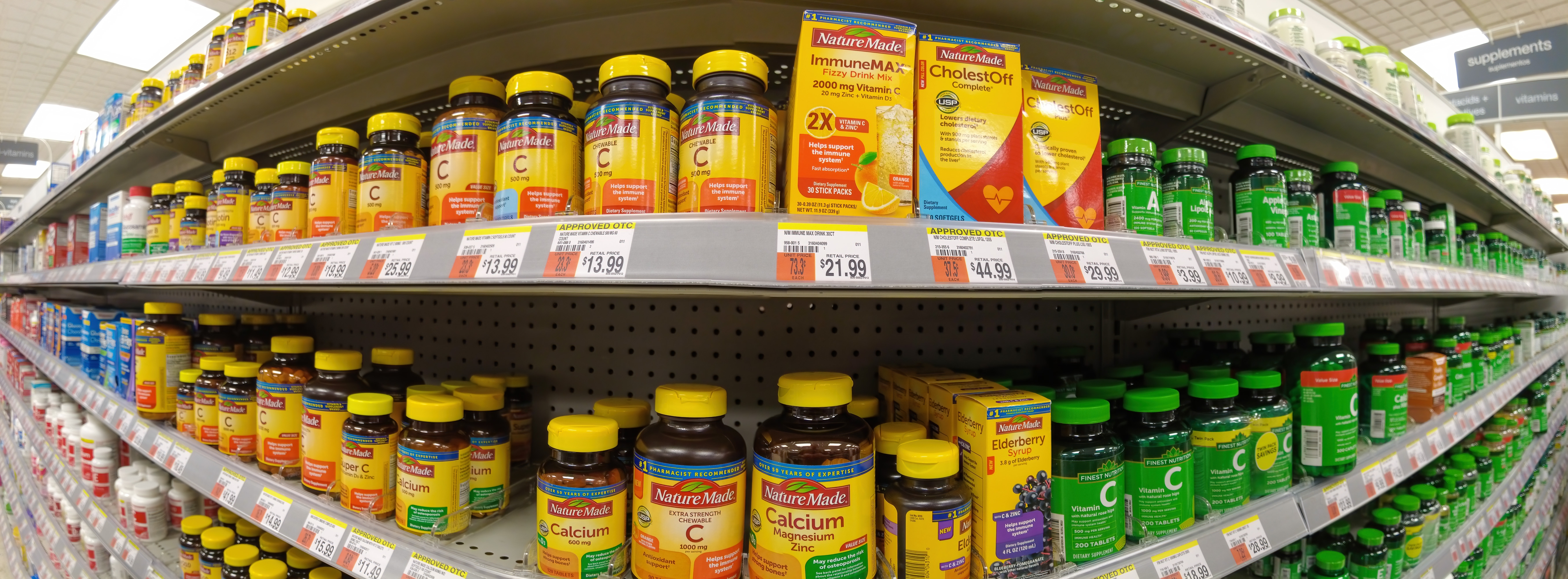 shelf in pharmacy with lots of bottles of vitamins shelf in pharmacy with lots of bottles of vitamins