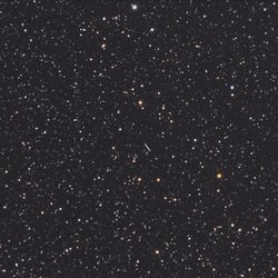 A picture of the night sky showing the stars and a line tracking the path of an asteroid.