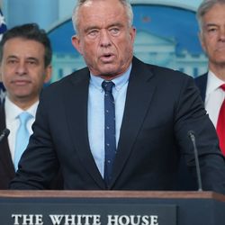 A picture of RFK Jr stood in front of a lectern that says "The White House, Washington". 