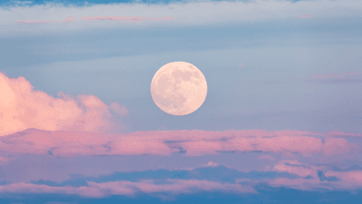 The Moon, above some clouds.