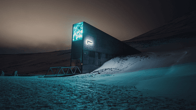 Svalbard Global Seed Vault, jutting out of the snow at night.