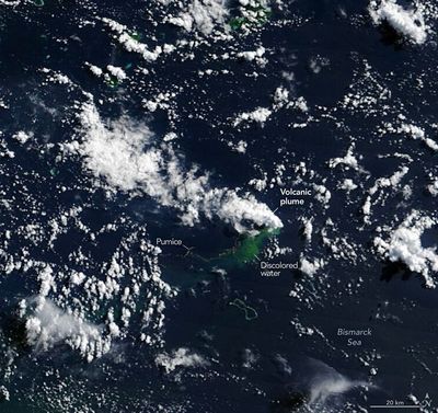 A satellite photo showing a plume of white steam rising from the water. Under it is a greenish patch of decolored water. To the left is a tiny line that has been labelled "pumice". Taken together, it is possible to see the contours of a shape under the water. 