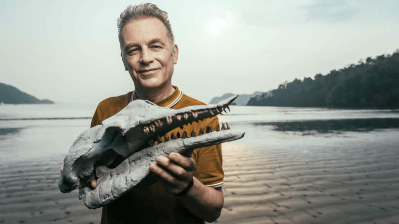 chris packham holds the replica skull of Simocetus rayi, an ancient early toothed whale.