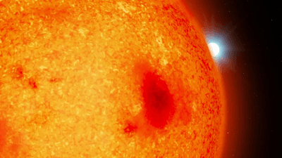a tiny white dwarf is coming out from behind a much larger red dwarf