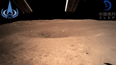 The surface of the far side of the Moon, with a small crater in view.