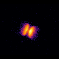 Image from HST showing the bipolar outflow of material ejected by the helium nova V445 Puppis. The progenitor binary star system is just about visible in the centre of the outflow. Also visible are the 'bullets' of gas that were shot out at either end of the outflow. Image taken in 2013 with the F502N filter on Hubble’s Wide Field Camera 3.