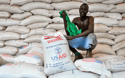 A man prepares food rations for people fleeing violence in South Sudan at the Kule refugee camp in Ethiopia.