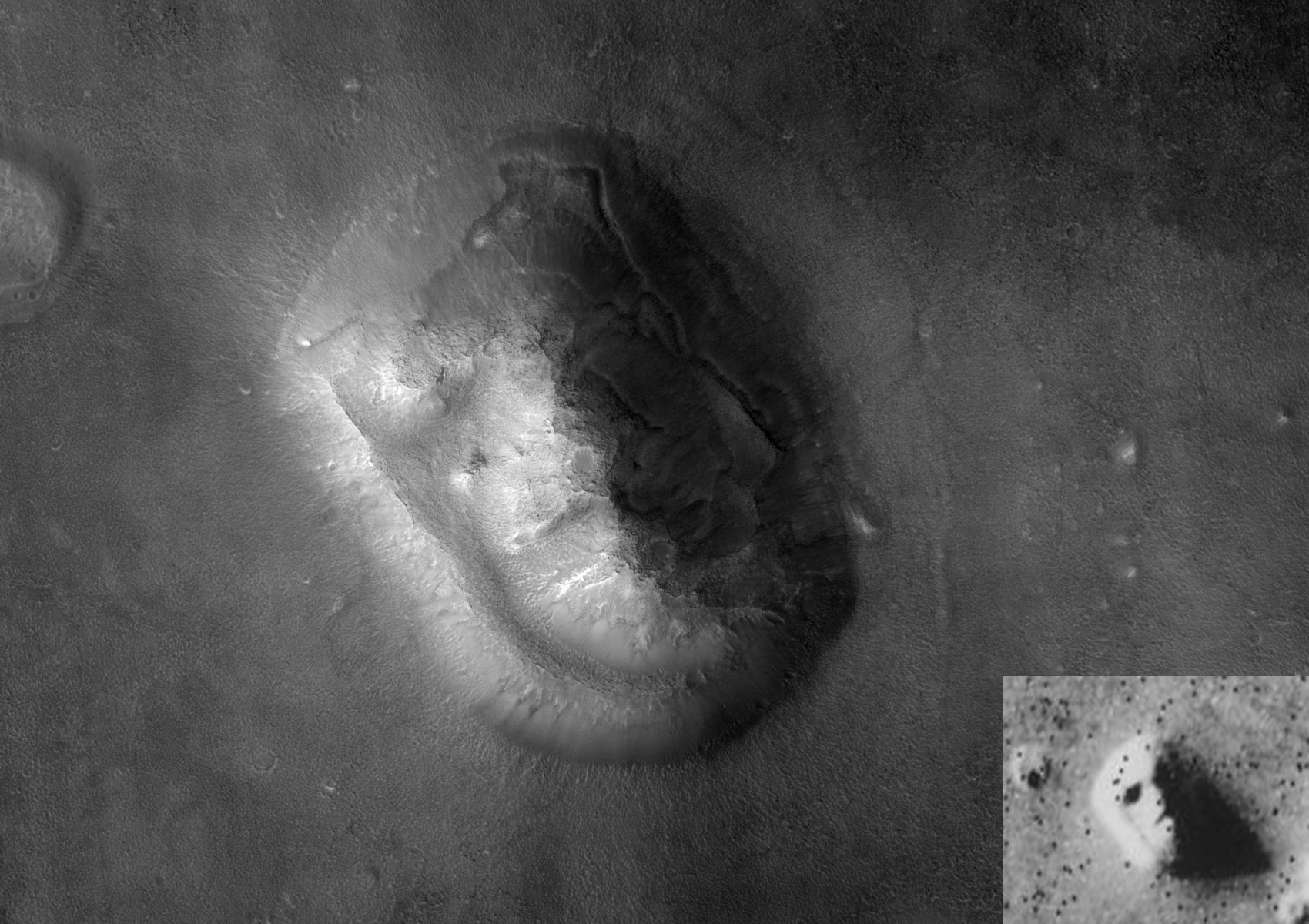 The High Resolution Imaging Science Experiment onboard the Mars Reconnaissance Orbiter show the face for waht really is a windswept hill 
