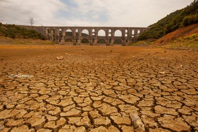 Turkey, Istanbul - 2017: Waterless dam in a dry and drought-affected landscape. The appearance of cracked soil when the waters receded in Alibeyköy dam