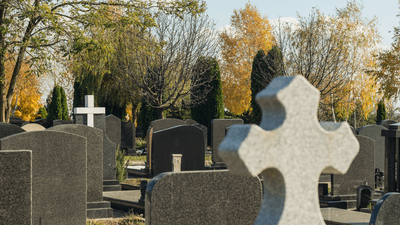 a cemetery including several cross-shaped tombstones