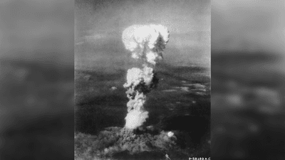 A black and white photograph of the mushroom cloud that erupted after the Little Boy atomic bomb was dropped on Hiroshima.