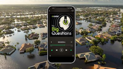 A picture of a mobile phone displaying The Big Questions logo overlaid on a picture of a flooded neigbourhood.